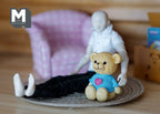 1:12 scale miniature teddy bear in a blue heart shirt, tan bear with a pink heart, sitting beside a posed figure