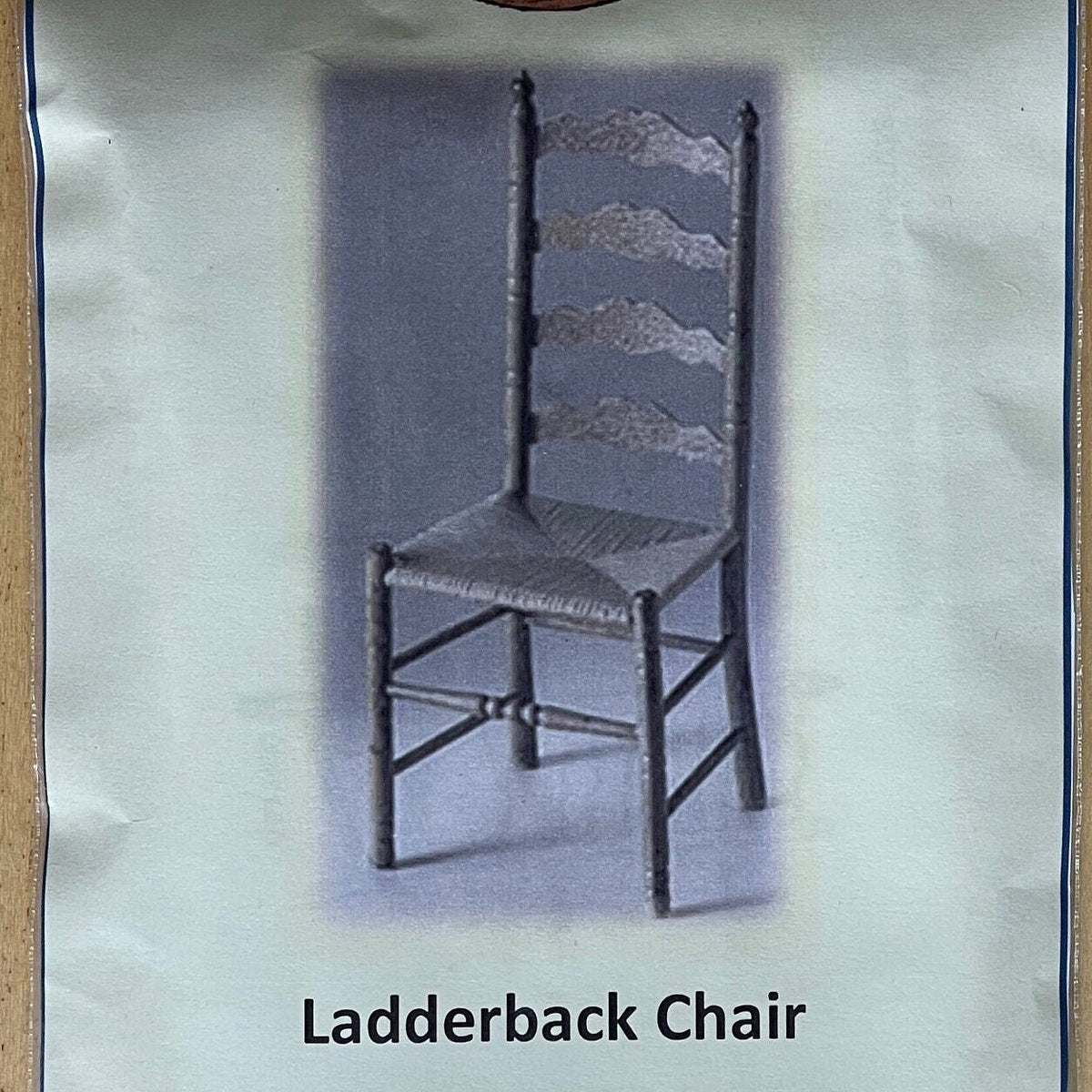 1:12 scale miniature ladderback chair kit, dark chair with four shaped back slats and woven seat shown on the package