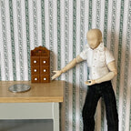1:12 scale miniature wood spice chest in brown with fixed drawers and white knobs, shown beside a posed figure