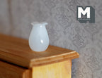 1:12 scale miniature milk glass vase in white with a ruffled rim, shown on a wood dresser