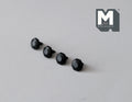 1:12 scale miniature matte black faceted cabinet knobs, set of 4, shown in a row on a gray surface