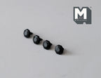 1:12 scale miniature matte black faceted cabinet knobs, set of 4, shown in a row on a gray surface