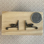 1:12 scale miniature metal wall brackets in antique bronze with bear and tree design, 1 pair, shown beside a coin