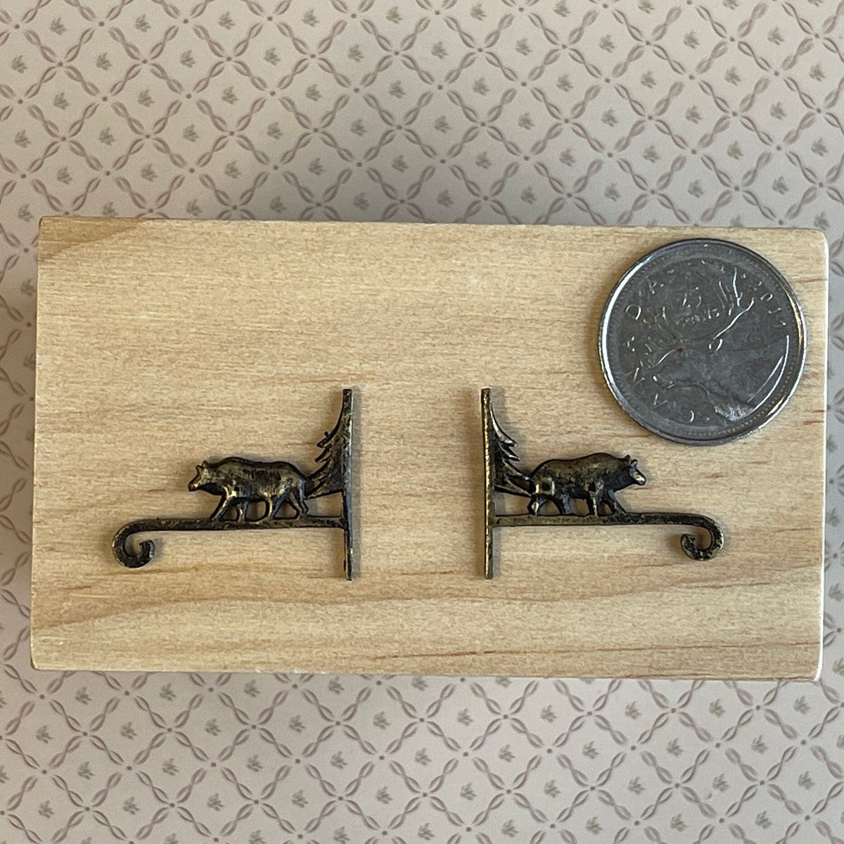 1:12 scale miniature metal wall brackets in antique bronze with bear and tree design, 1 pair, shown beside a coin
