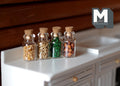 1:12 scale miniature glass spice jars with cork lids, set of 5, filled with colorful spices, on a white kitchen counter