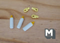1:12 scale miniature baby feeding set with 3 white bottles and yellow pacifiers, shown on a wood surface