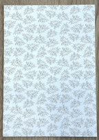 1:12 scale miniature pale floral peel and stick wallpaper in light blue, delicate gray leaf sprigs on white