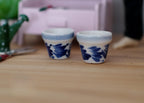 1:12 scale miniature ceramic round flower pots in blue and white floral, large, set of 2, on a wood table