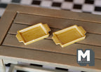 1:12 scale miniature ceramic trays with handles in mustard yellow, set of 2, shown side by side on a slatted wood table