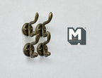 1:12 scale miniature antique bronze wall hooks with double curved prongs, set of 4, on a white surface