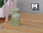 1:12 scale miniature celadon green ceramic baluster vase with narrow neck, shown on a wood table