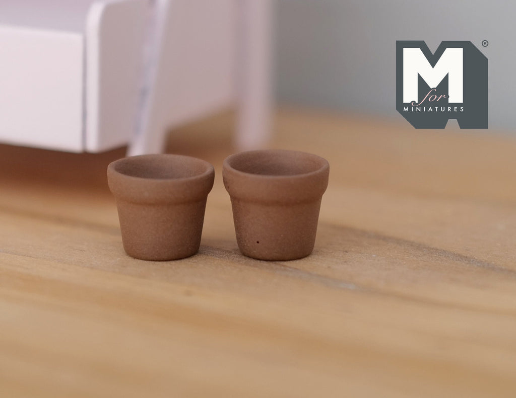 1:12 scale miniature clay flower pots with rim, set of 2, unglazed terracotta, shown empty on a wood floor
