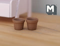 1:12 scale miniature clay flower pots with rim, set of 2, unglazed terracotta, shown empty on a wood floor
