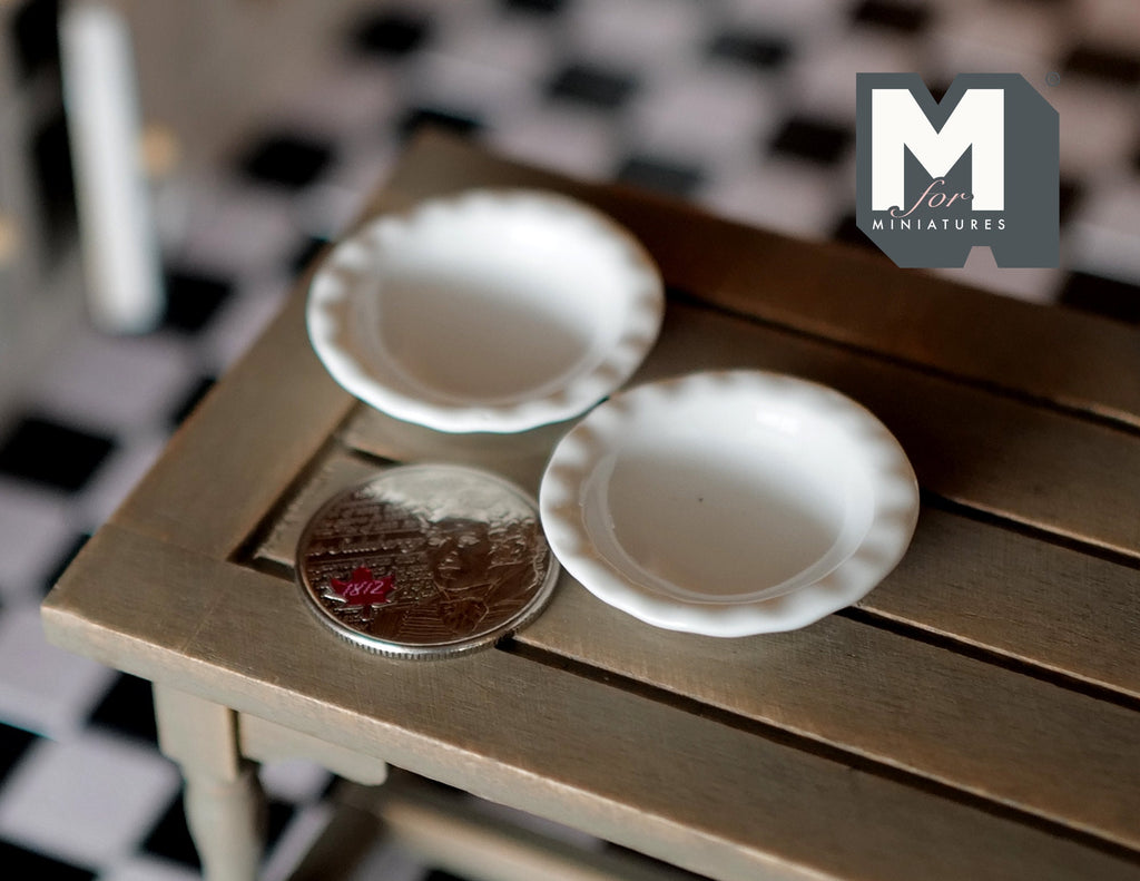 1:12 scale miniature white ceramic shallow bowls with fluted rims, set of 2, shown on a wood table beside a coin