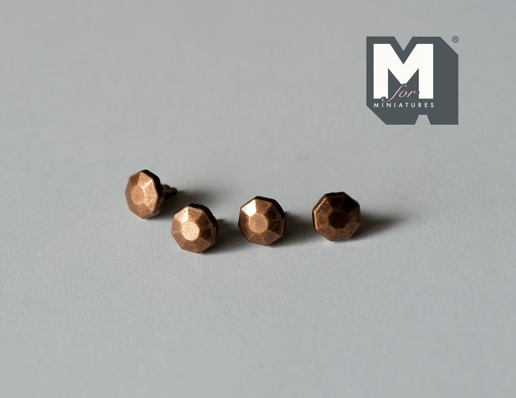 1:12 scale miniature antique bronze faceted cabinet knobs, set of 4, shown in a row on a gray surface