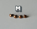 1:12 scale miniature copper domed cabinet knobs with pin backs, set of 4, shown in a row on a gray surface