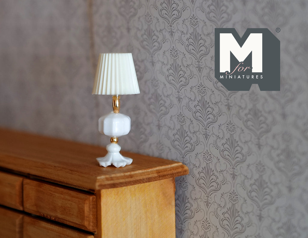 1:12 scale miniature table lamp with white pleated shade and white base, non-electric, shown on a wood dresser