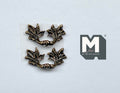 1:12 scale miniature leaf end drawer pulls in antique brass, set of 2, ornate curved handles on a white surface