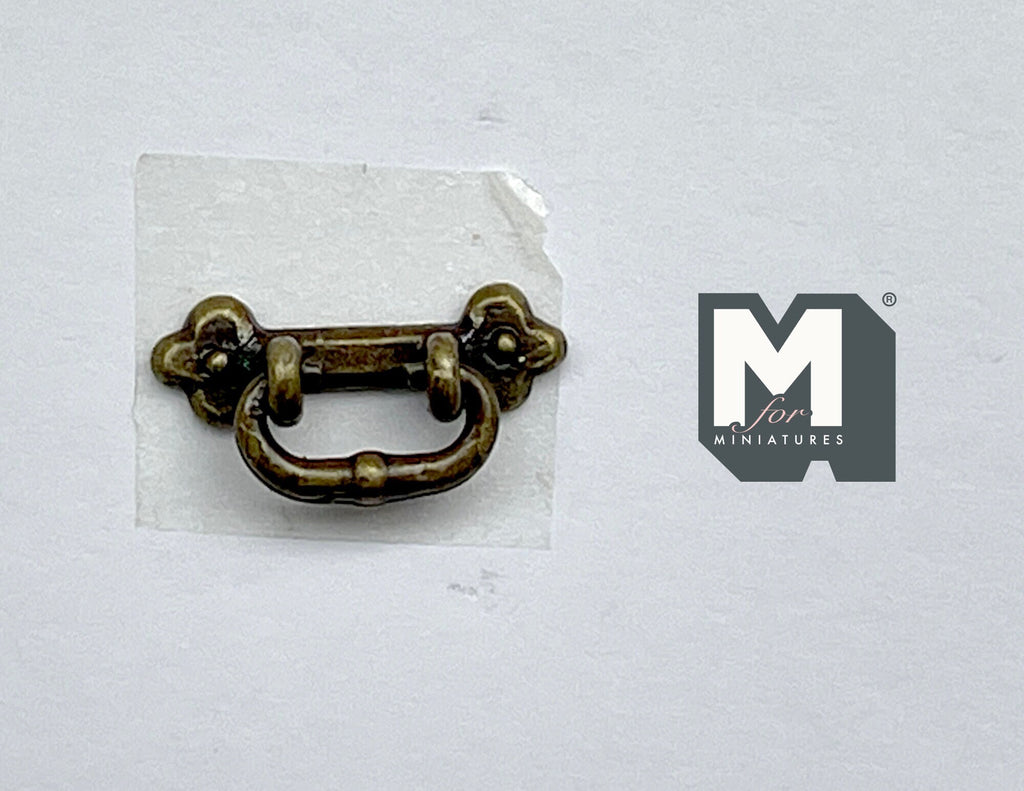 1:12 scale miniature bail drawer pull with clover backplate in antique brass, shown on a white background