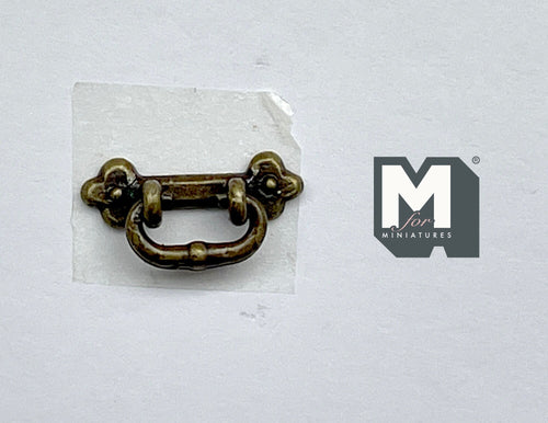 1:12 scale miniature bail drawer pull with clover backplate in antique brass, shown on a white background