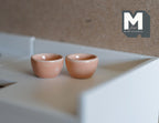 1:12 scale miniature ceramic bowls in peach, small, set of 2, glossy round bowls shown on a white counter