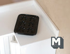 1:12 scale miniature cast resin gingerbread man baking pan in black with 6 molds, shown on a white counter