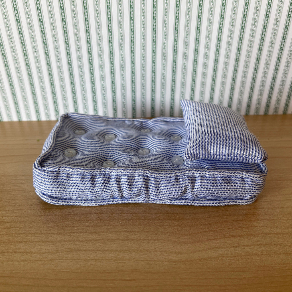 1:12 scale miniature single mattress with pillow in lavender stripe fabric, button tufted, on a wood floor