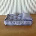 1:12 scale miniature single mattress with pillow in lavender stripe fabric, button tufted, on a wood floor