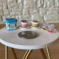 1:12 scale miniature assorted ice cream and plates, set of 7, tubs and cups with printed labels, beside a coin