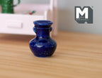 1:12 scale miniature ceramic vase in cobalt blue, round with flared neck and small handles, shown on a wood table