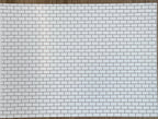 Miniature white embossed subway tile sheet with dark grout, full sheet view of the brick bond pattern
