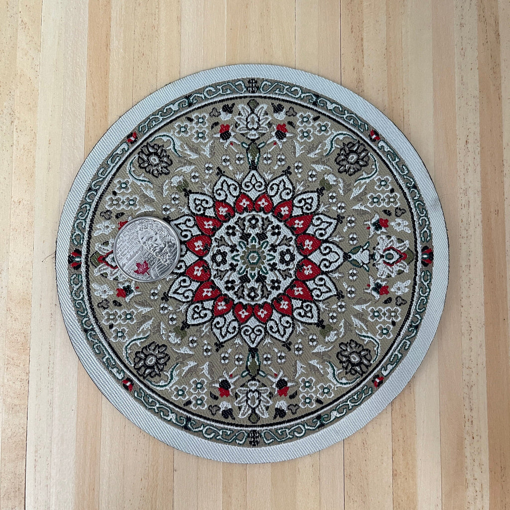 1:12 scale miniature round area rug in gray and red with center medallion and border, shown on a wood floor with a coin