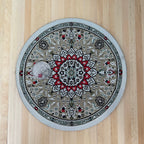 1:12 scale miniature round area rug in gray and red with center medallion and border, shown on a wood floor with a coin