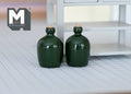 1:12 scale miniature carboy bottles in dark green, set of 2, with cork stoppers and side handles, shown on a tile floor