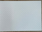 Miniature white embossed subway tile sheet with light grout, running bond brick pattern, full sheet shown flat