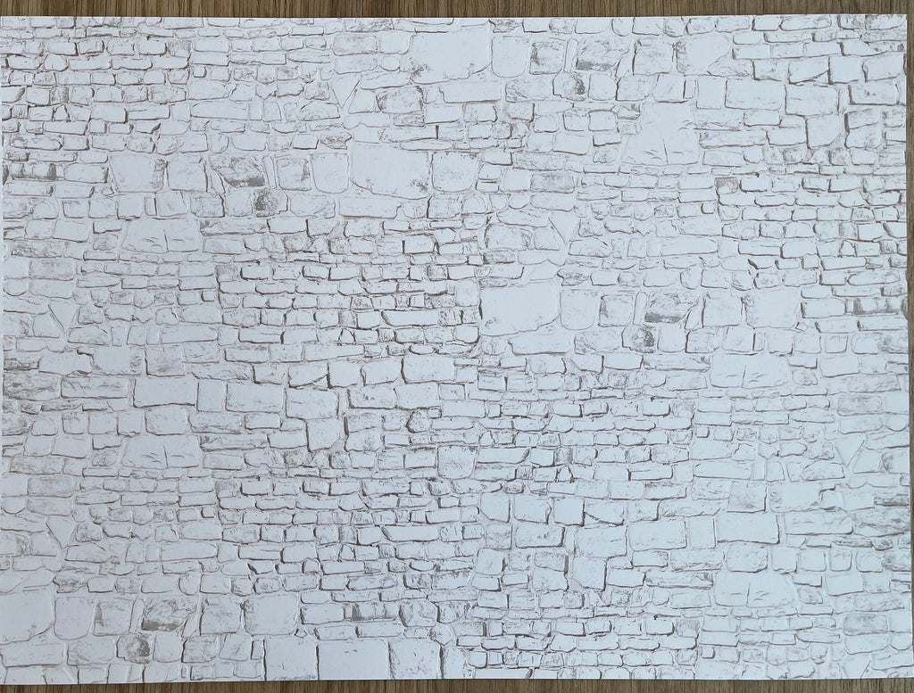 Miniature whitewashed embossed stone wall sheet with irregular stacked stone texture in white