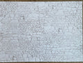Miniature whitewashed embossed stone wall sheet with irregular stacked stone texture in white