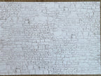 Miniature whitewashed embossed stone wall sheet with irregular stacked stone texture in white