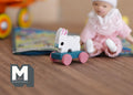 1:12 scale miniature rabbit pull toy with fixed wheels, white bunny on a teal base with pink wheels, on a wood floor