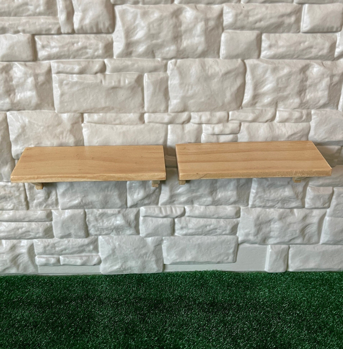 1:12 scale miniature stained wood wall shelves, set of 2, light wood planks shown mounted on a white stone wall