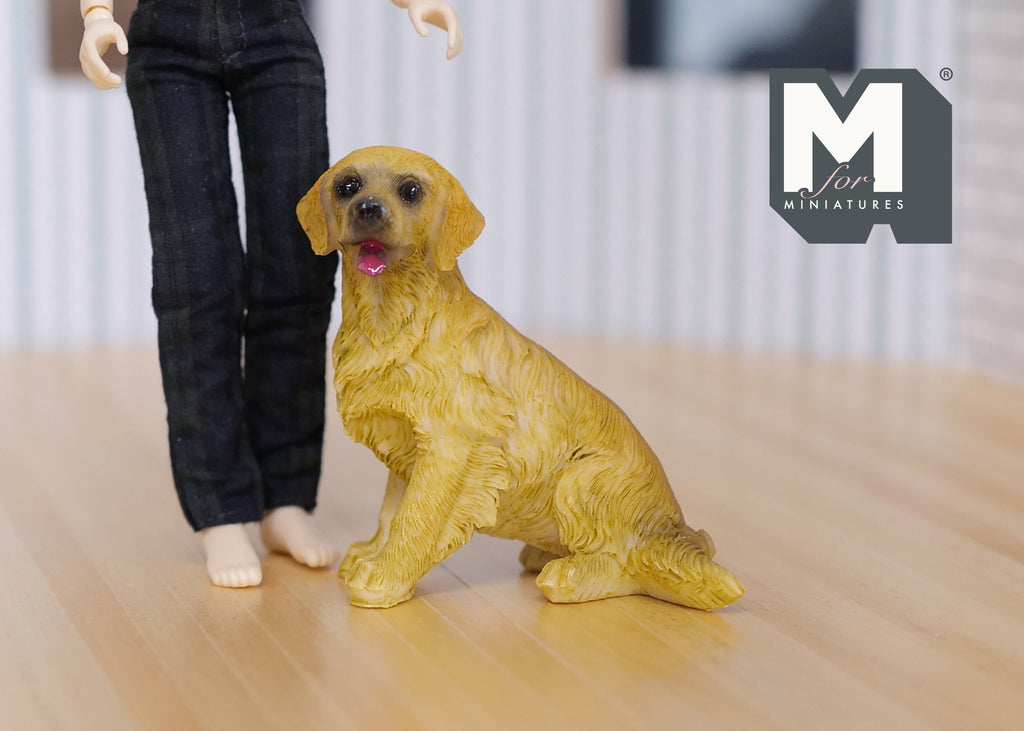 1:12 scale miniature sitting golden retriever dog with open mouth, shown on a wood floor beside a doll