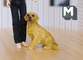 1:12 scale miniature sitting golden retriever dog with open mouth, shown on a wood floor beside a doll