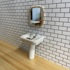 1:12 scale miniature ceramic pedestal sink with faucet, white rectangular basin, shown against a white tiled wall