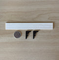 1:12 scale miniature wood wall shelf with black scroll metal brackets and nails, parts laid out beside a coin