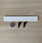 1:12 scale miniature wood wall shelf with black scroll metal brackets and nails, parts laid out beside a coin