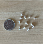 1:12 scale miniature unpainted wood mushroom door knobs, set of 12, shown scattered on a wood surface beside a coin