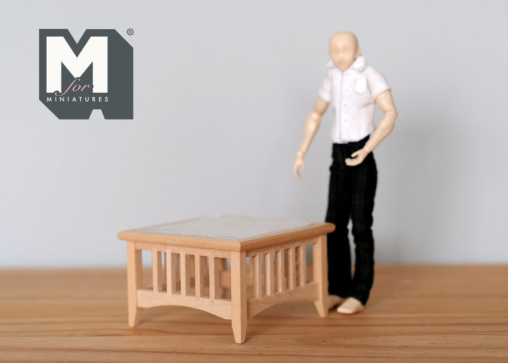 1:12 scale miniature unpainted wood coffee table, square with slatted sides, shown beside a poseable figure for scale
