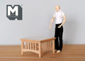 1:12 scale miniature unpainted wood coffee table, square with slatted sides, shown beside a poseable figure for scale
