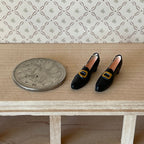 1:12 scale miniature women's buckled loafers in black with gold buckles and low heels, 1 pair, beside a coin
