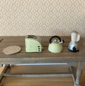 1:12 scale miniature toaster, kettle and blender in mint green resin, set of 3, shown on a wood table with a coin